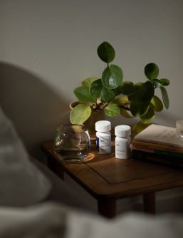 Kick
              Trazodone and Gabapentin sleep prescription bottles on bedside
              stand