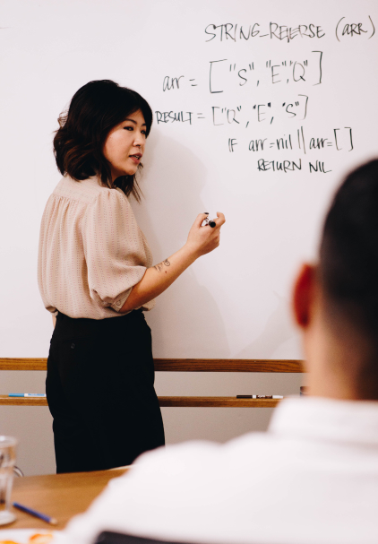 woman leading coworkers through a meeting presentation