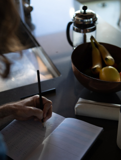 Man filling out his Kick sleep journal during breakfast